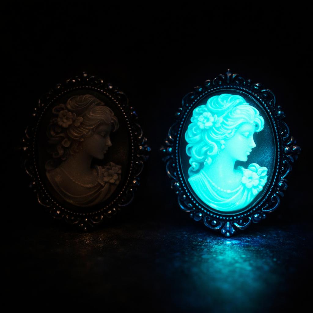 Two cameos under UV blacklight — the resin cameo on the right fluoresces bright blue-green while the shell cameo on the left stays dark and inert