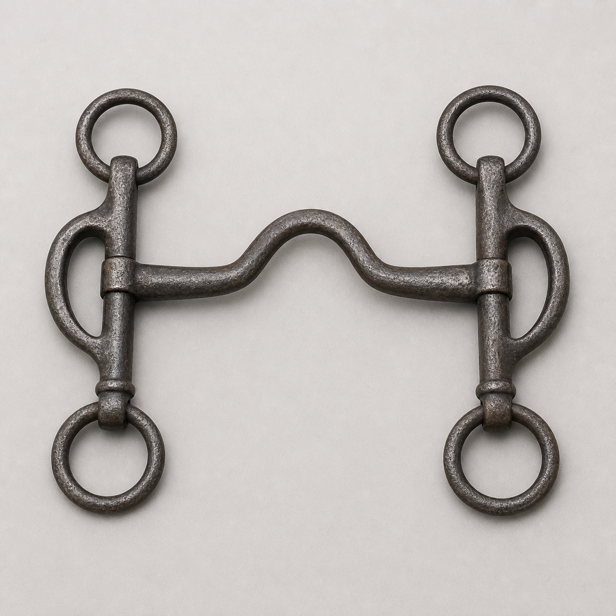 Antique horse bit details showing mouthpiece, cheeks, metal wear, and maker clues