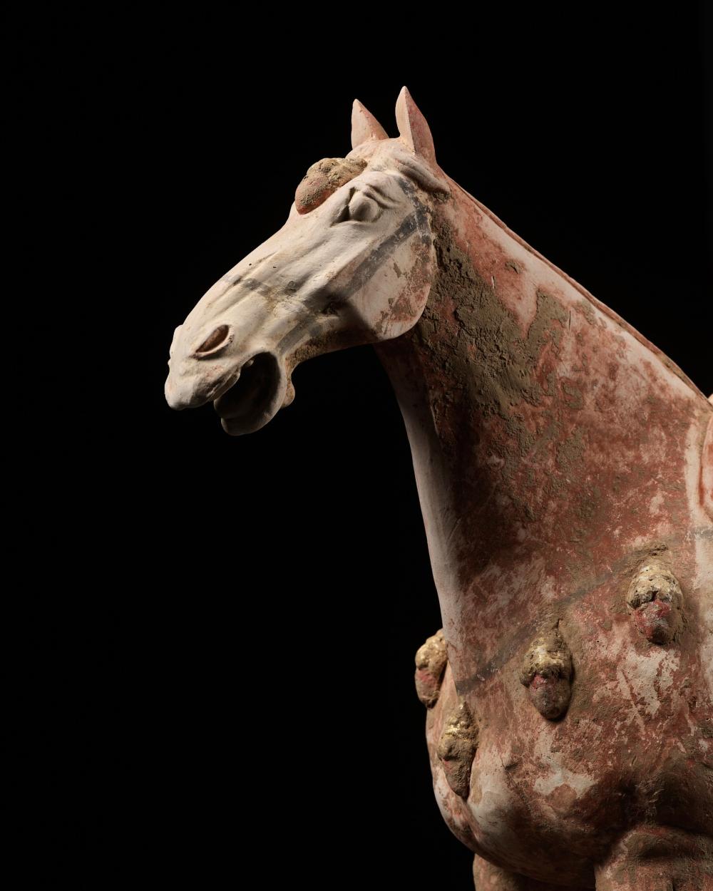 Auction comp thumbnail for A PAINTED AND GILT POTTERY FIGURE OF A PRANCING HORSE, TANG DYNASTY (Galerie Zacke, Lot 238)