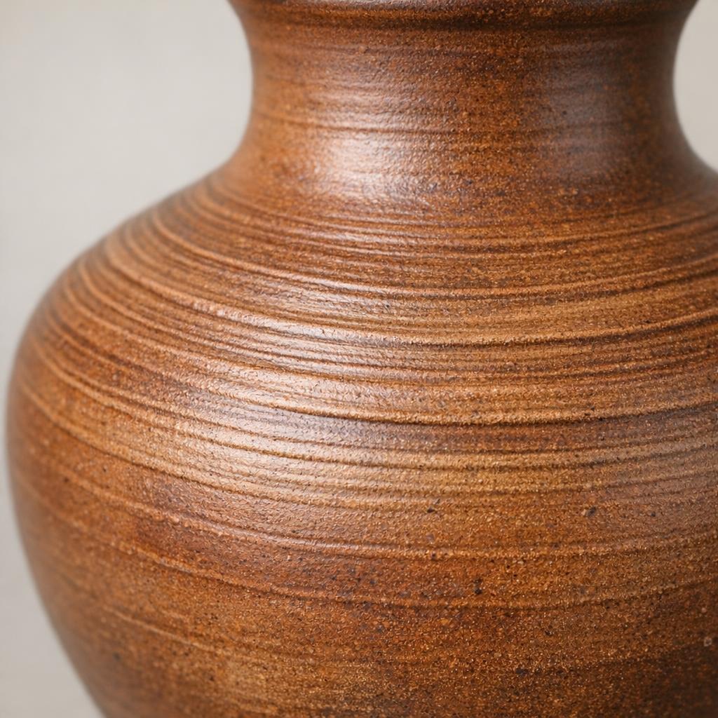 Throwing rings visible on a wheel-thrown pottery body