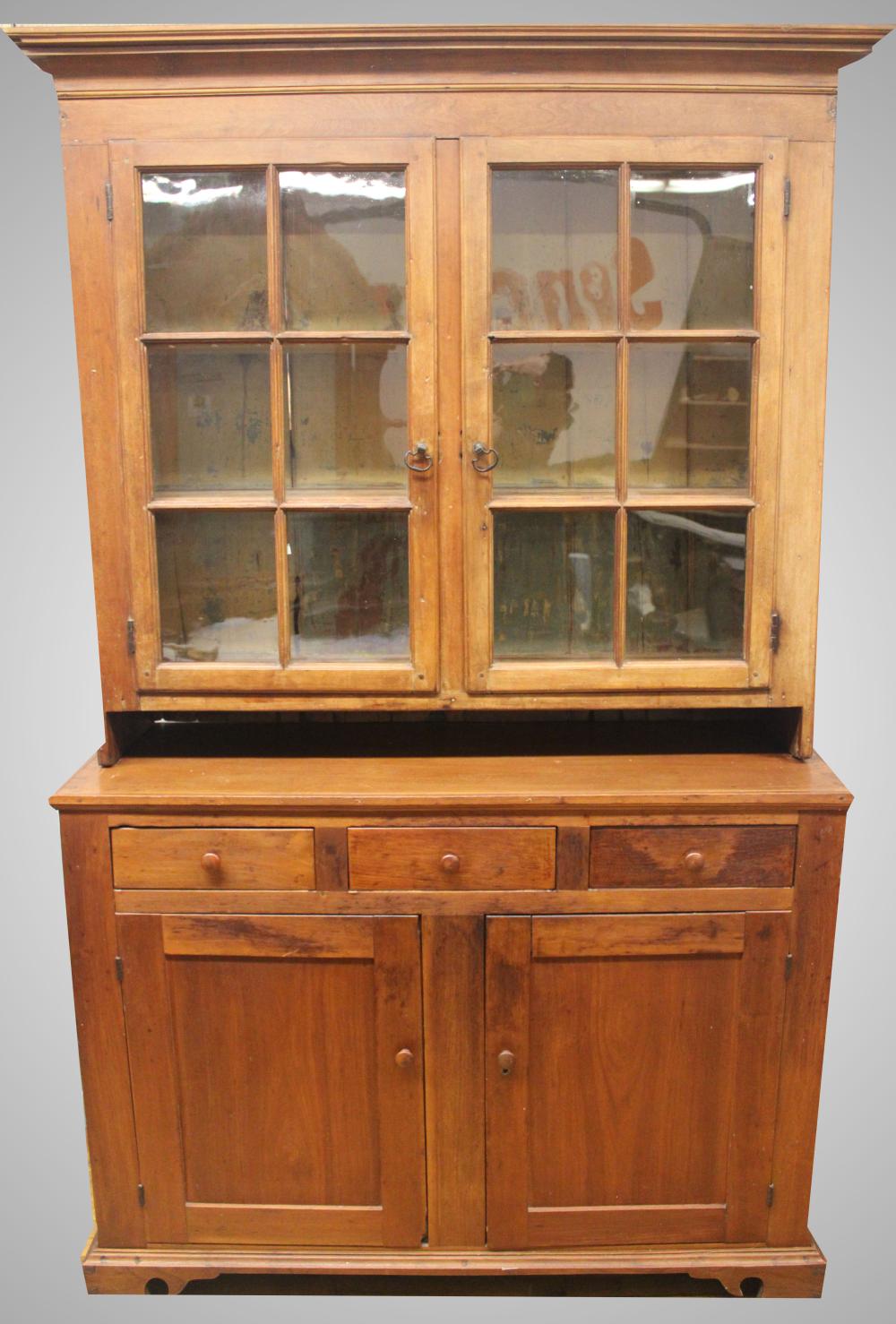 Auction comp thumbnail for TWC – Furniture: Antique two-piece cupboard; mixed wood cherry, walnut & softwood; double blind door base with three drawers over; double glass door top with six panes each; cut out spoon racks @shelf fronts; natural interior with traces of old bl (Roan Inc. Auctioneers & Appraisers, Lot 270)