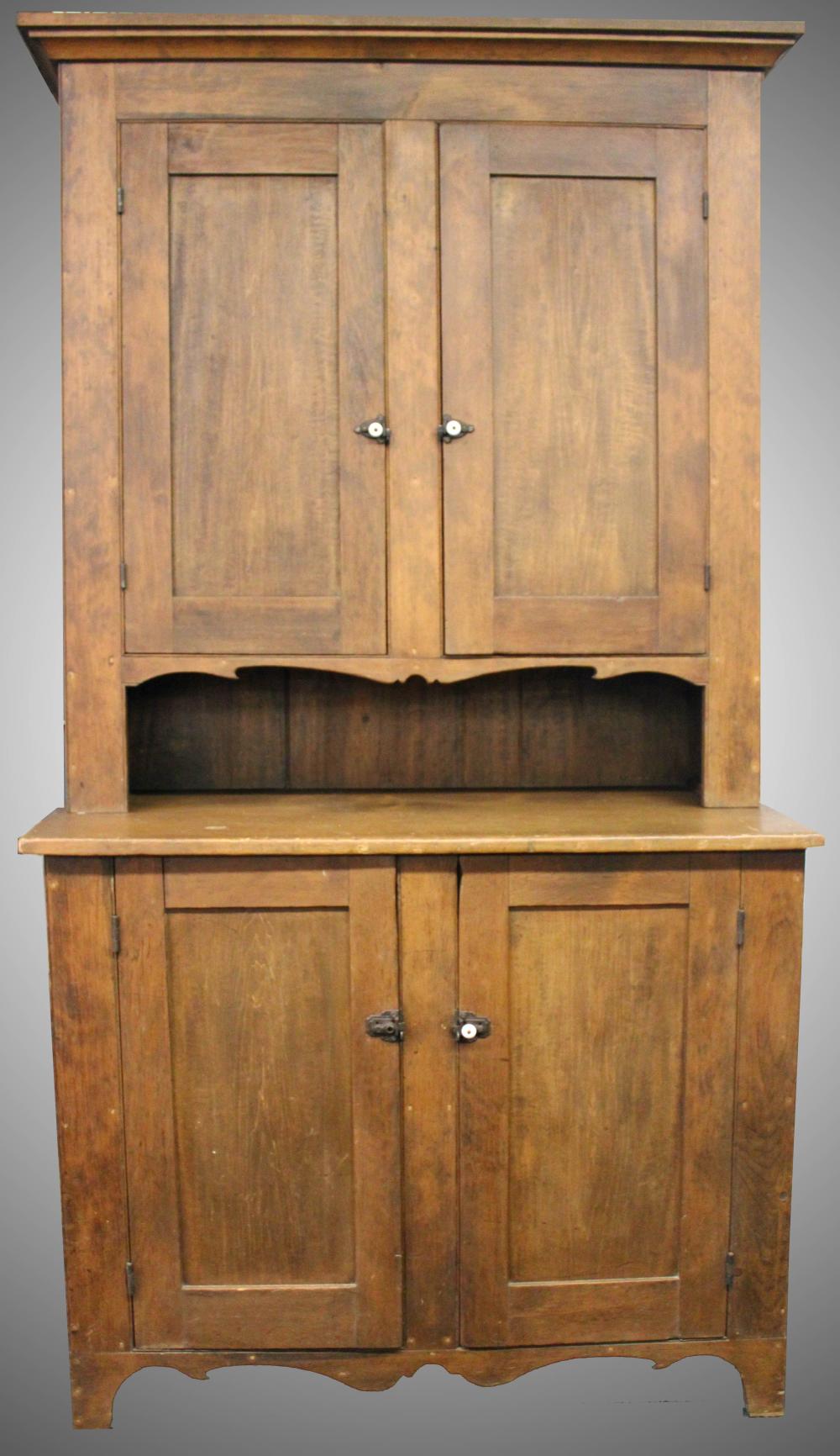 Auction comp thumbnail for PC – Furniture: Antique step back wall cupboard, two-piece softwood, blind doors– two doors over two doors; in natural refinish; shelves interior; iron spring latches (one `missing a white porcelain knob) 48 ½” W X 23” D @base X 85 ½” T (Good) NO (Roan Inc. Auctioneers & Appraisers, Lot 70)