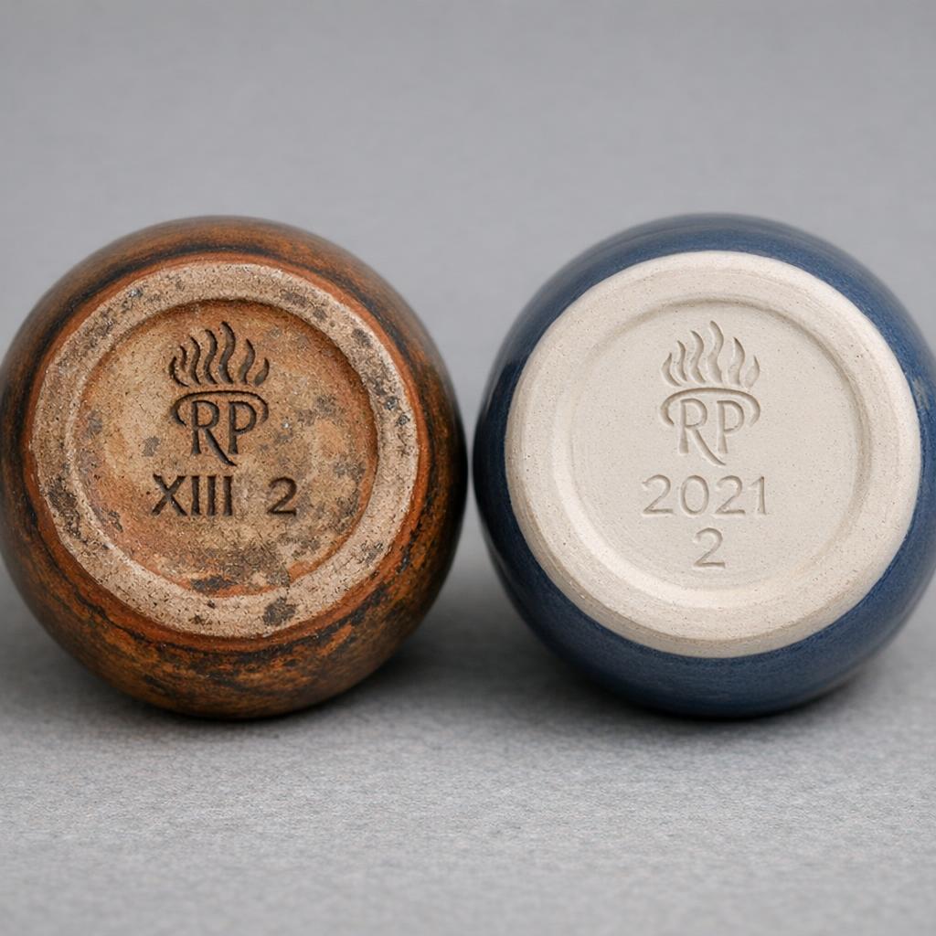 Side by side comparison of original antique Rookwood pottery base with Roman numerals and modern Townley revival reproduction with Arabic numerals