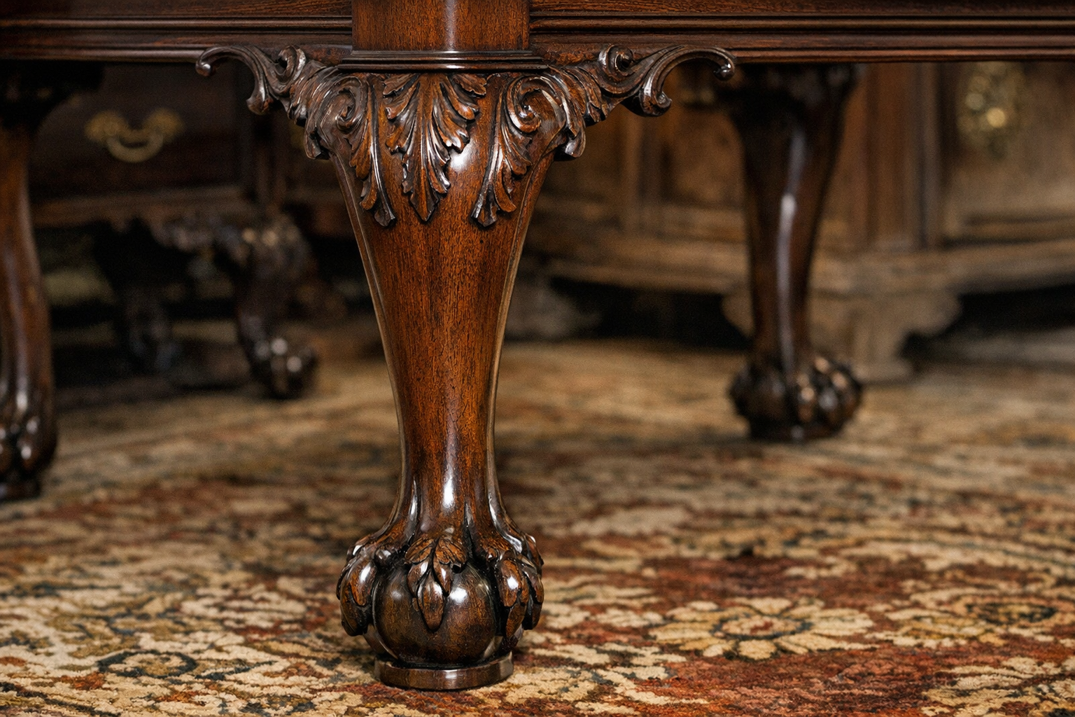 Close-up of ornate cabriole legs with ball and claw feet typical of the Queen Anne period