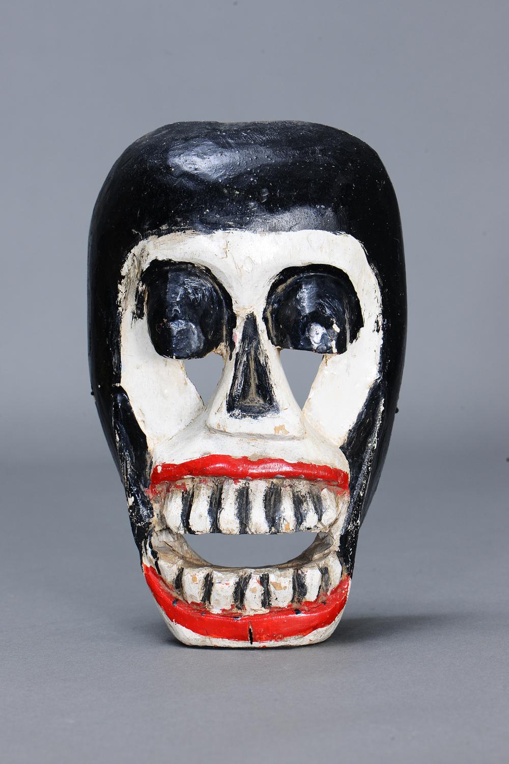 Auction catalog photo of a Mexican death mask lot 189