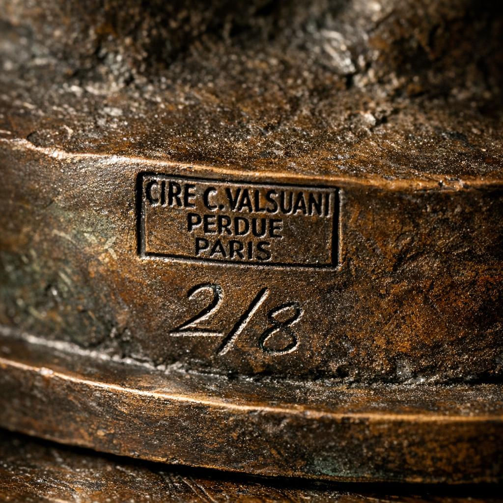 Bronze sculpture base showing a foundry stamp and hand-engraved edition number