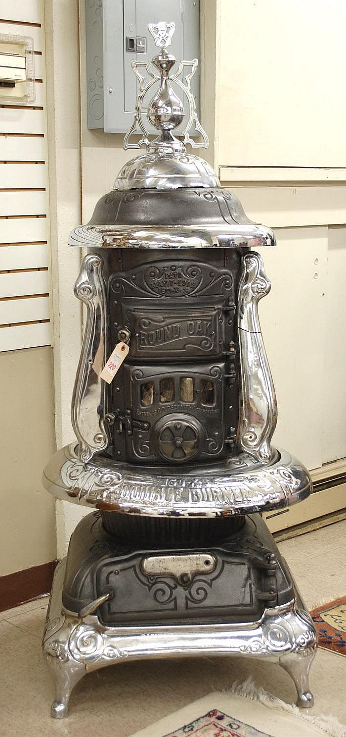 Auction comp thumbnail for CAST IRON WOOD BURNING PARLOR HEATING STOVE, Round (O'Gallerie, Lot 220)