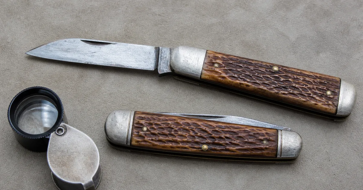 Vintage Old Timer-style pocket knives arranged for tang stamp and condition review