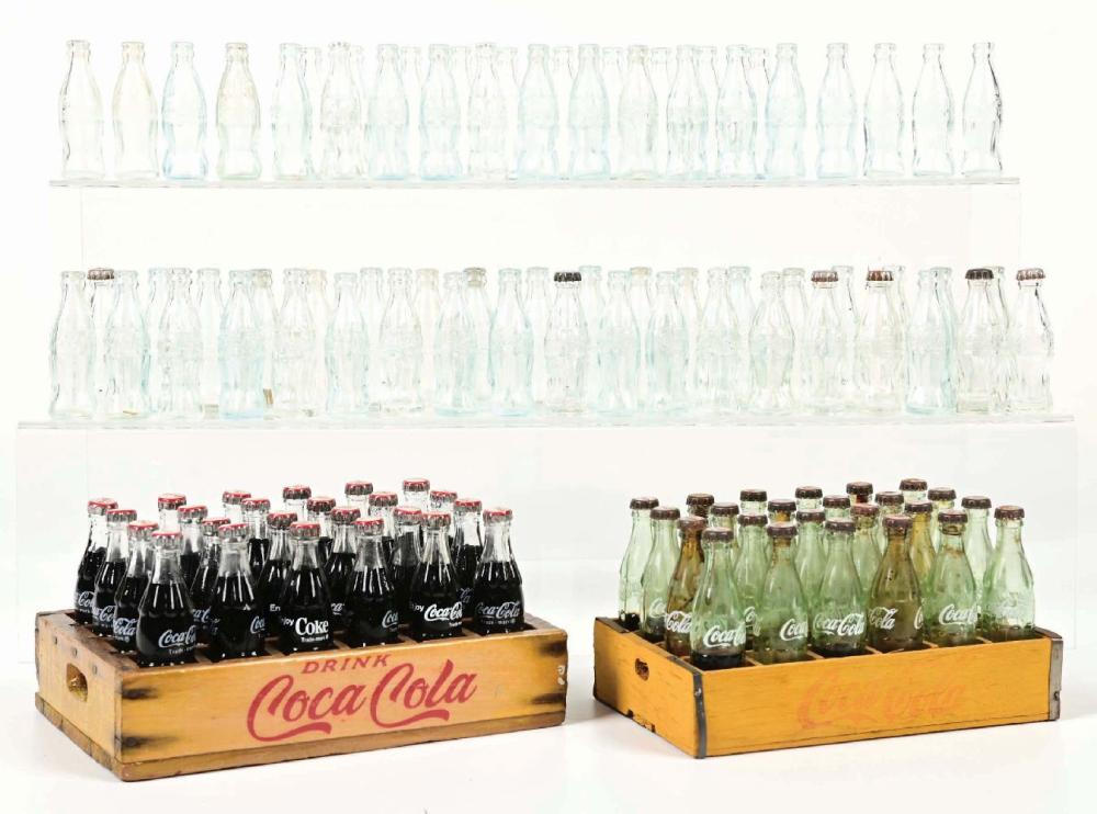 Auction comp thumbnail for EARLY WOODEN CASES FILLED WITH MINI COCA-COLA BOTTLES & REPLACEMENT BOTTLES (Morphy Auctions, Lot 2233)