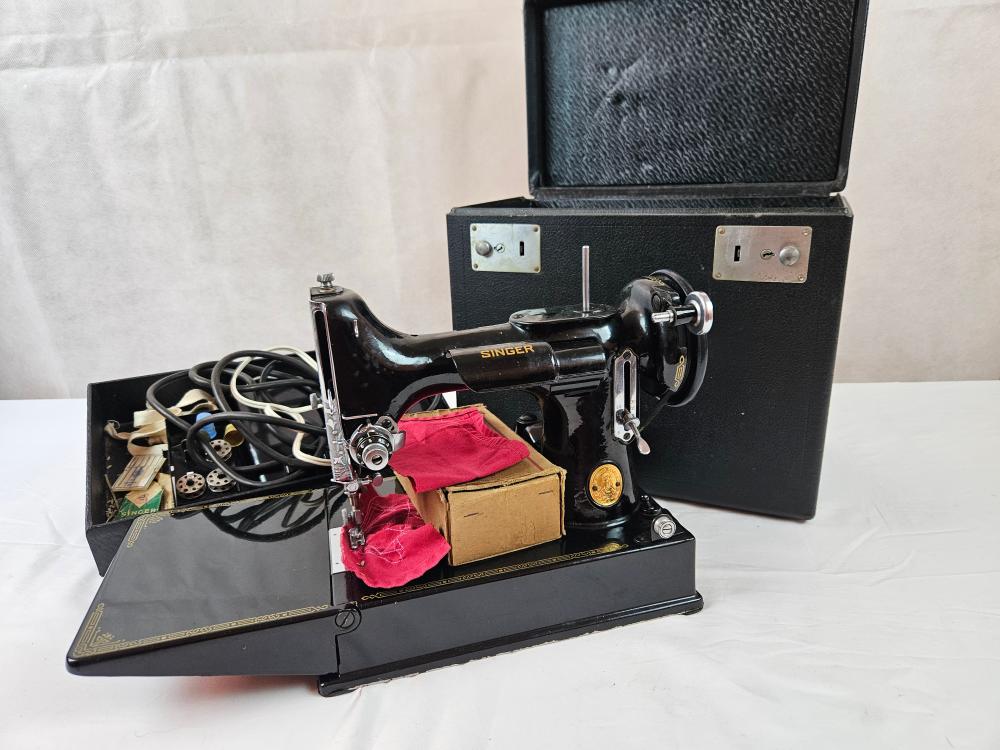 Auction comp thumbnail for Singer sewing machine portable, in carry case with… (Amanda Addams Auctions, Lot 87)