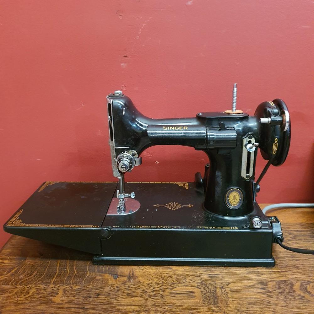 Auction comp thumbnail for Portable Vintage Electric Singer Sewing Machine, Featherweight or Singer 221; 1951 to 1951, a Century of Sewing Service. The box measures 30 cm high x 34 cm wide x 21 cm deep. (Because Auctions, Lot 8052)
