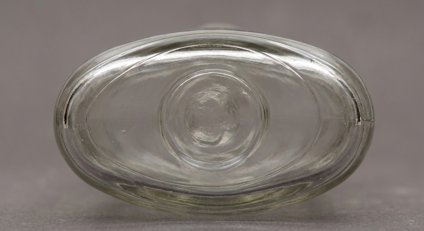 Close-up of a bottle bottom showing a perfect circular Owens suction scar