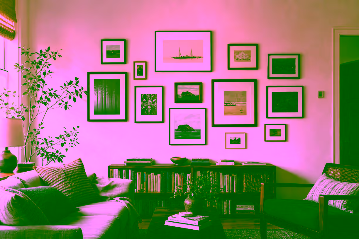 Lived-in home interior with a personal wall collection of framed works in mixed sizes and a slightly asymmetric arrangement.